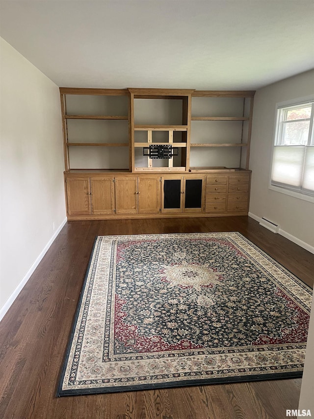 1725 Elmwood Ln, Bettendorf, IA 52722 - unfurnished living room featuring baseboards, dark wood-type flooring, and a baseboard radiator