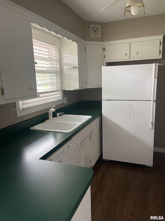1725 Elmwood Ln, Bettendorf, IA 52722 - kitchen with freestanding refrigerator, white cabinetry, a sink, and dark wood finished floors