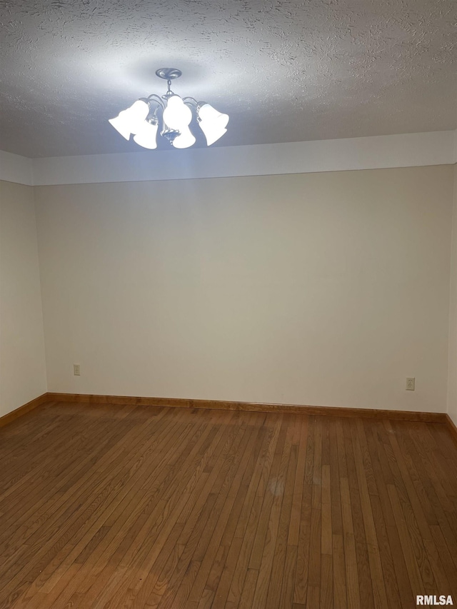 5833 Taylor St, Davenport, IA 52806 - unfurnished room featuring hardwood / wood-style floors, a chandelier, baseboards, and a textured ceiling