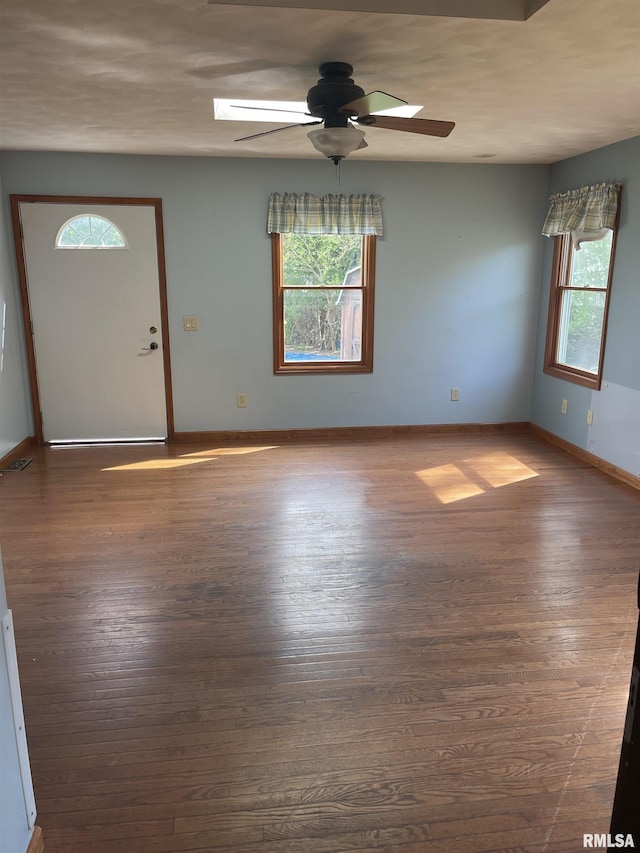 5833 Taylor St, Davenport, IA 52806 - unfurnished room with healthy amount of natural light, a ceiling fan, and hardwood / wood-style floors