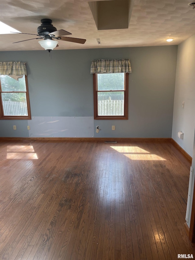 5833 Taylor St, Davenport, IA 52806 - empty room with healthy amount of natural light, ceiling fan, hardwood / wood-style floors, and baseboards