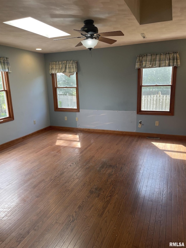 5833 Taylor St, Davenport, IA 52806 - spare room with ceiling fan, hardwood / wood-style flooring, plenty of natural light, and a skylight