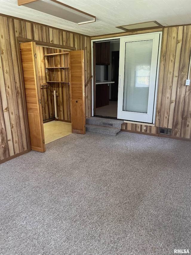 5833 Taylor St, Davenport, IA 52806 - unfurnished room featuring wood walls and carpet flooring