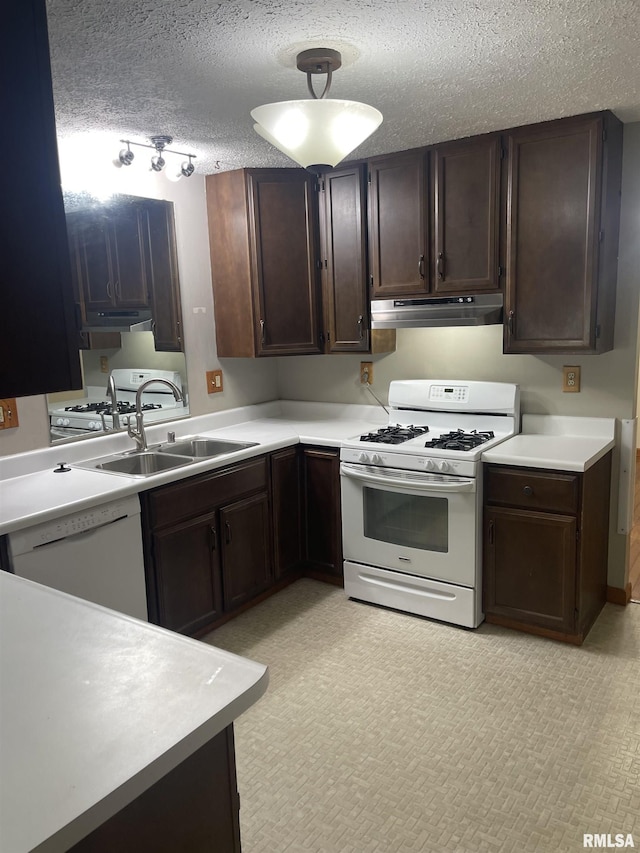 5833 Taylor St, Davenport, IA 52806 - kitchen with white appliances, a sink, under cabinet range hood, dark brown cabinets, and a textured ceiling
