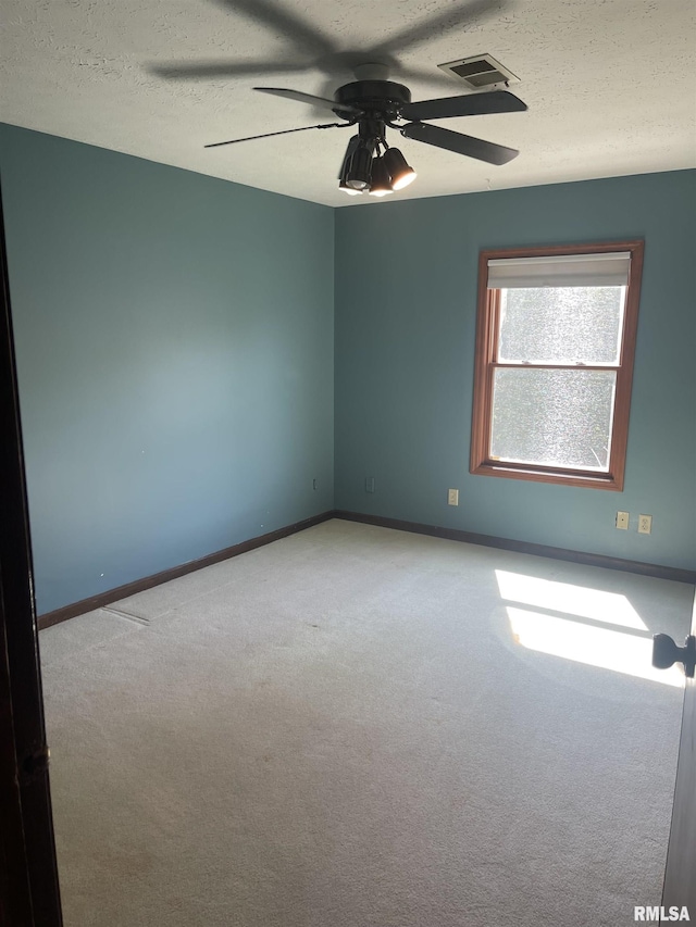 5833 Taylor St, Davenport, IA 52806 - carpeted empty room with a ceiling fan, a textured ceiling, and baseboards