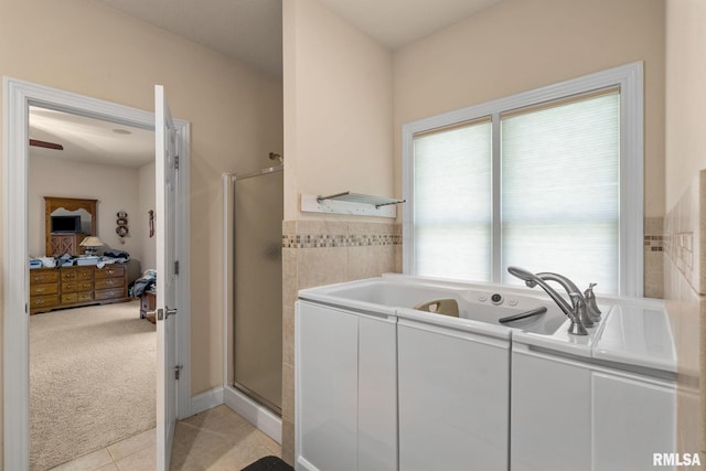 full bathroom featuring tile patterned flooring, a tub with jets, connected bathroom, and a stall shower