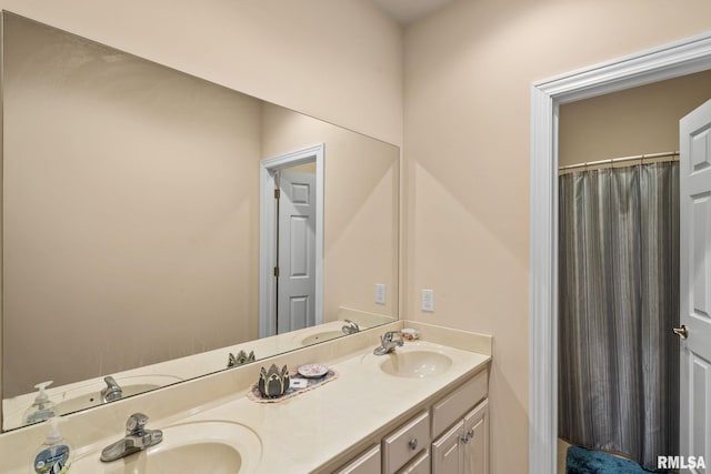 bathroom with a sink and double vanity
