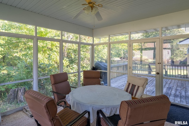 sunroom with a ceiling fan, a wealth of natural light, and outdoor dining area