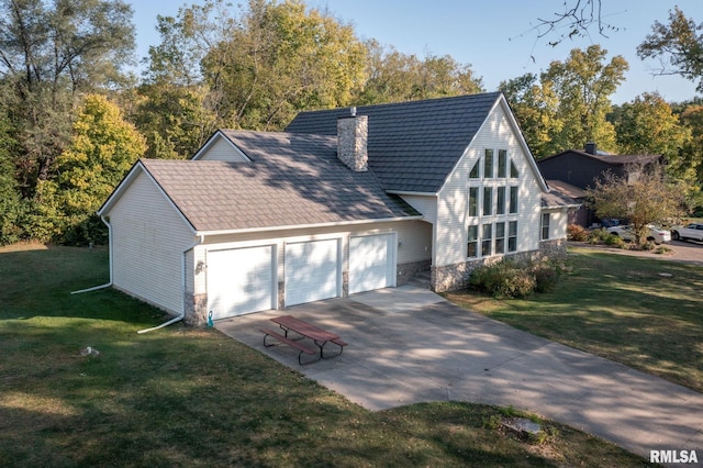 view of front of house with a garage, driveway, a chimney, and a front lawn