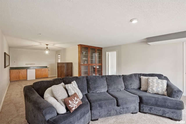 living room featuring baseboards, a textured ceiling, and light carpet