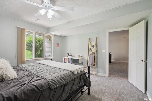 bedroom with visible vents, baseboards, ceiling fan, a textured ceiling, and carpet flooring