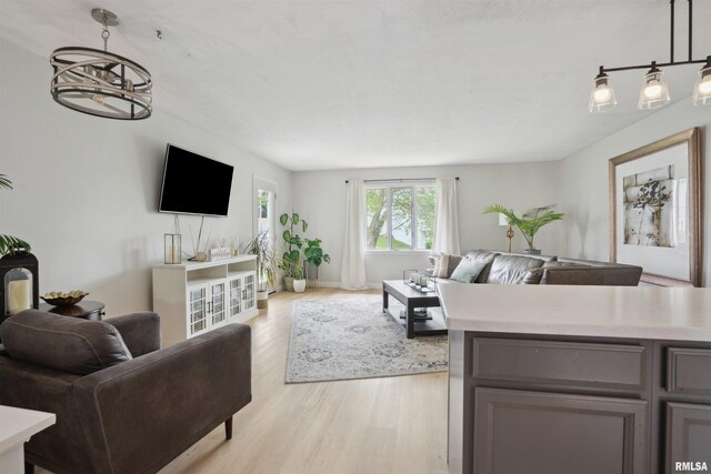 living room featuring light wood-type flooring and baseboards
