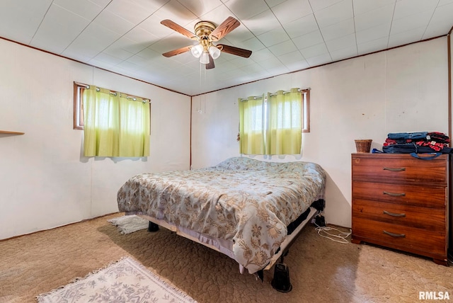 bedroom featuring ceiling fan and carpet