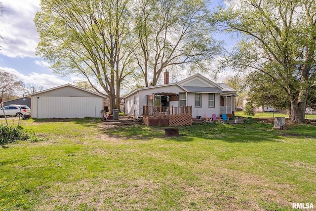 back of property with a yard and a deck