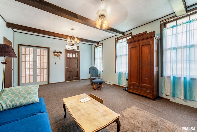 living area with baseboards, carpet floors, beam ceiling, and ceiling fan with notable chandelier