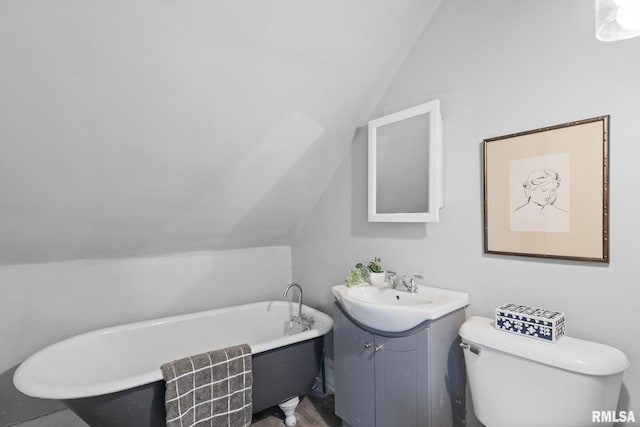 2129 Washington St, Davenport, IA 52804 - bathroom featuring vaulted ceiling, vanity, a freestanding bath, and toilet