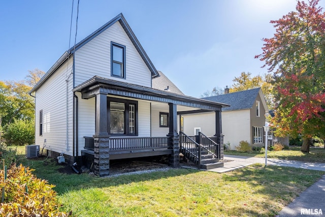 2129 Washington St, Davenport, IA 52804 - bungalow with cooling unit, a porch, a front lawn, and a garage