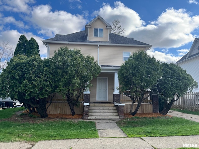 view of front of house featuring fence, a porch, and roof with shingles