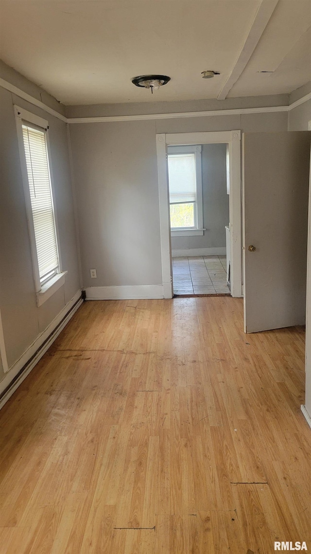 1306 Davie St, Davenport, IA 52804 - unfurnished room featuring light wood finished floors and a baseboard radiator