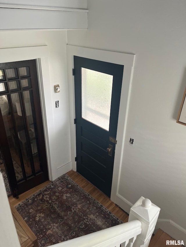 interior space with baseboards and wood finished floors