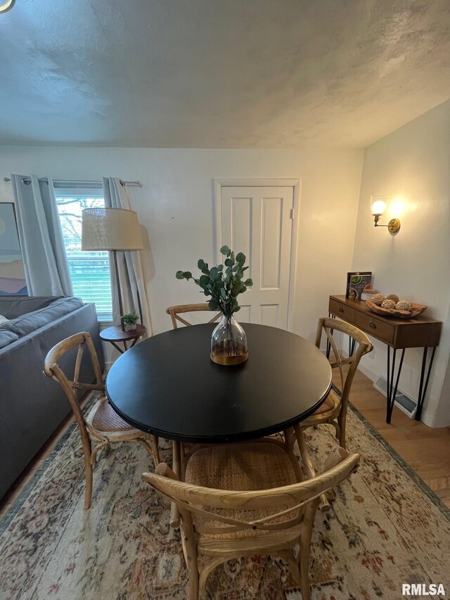 living room with wood finished floors and a notable chandelier