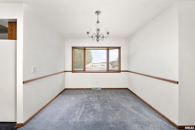 unfurnished room featuring a chandelier, carpet flooring, baseboards, and visible vents