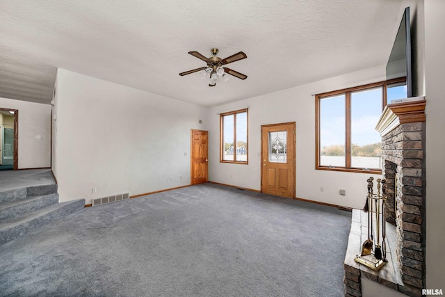 unfurnished living room with stairs, carpet, visible vents, ceiling fan, and baseboards