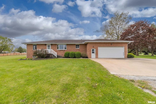 single story home with an attached garage, a front lawn, brick siding, and driveway