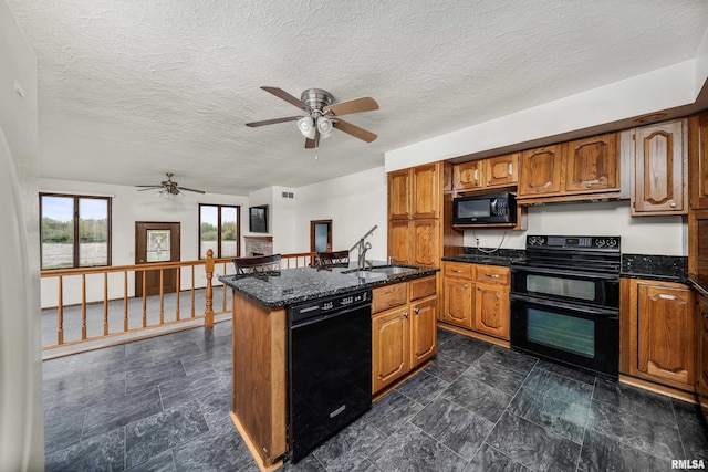 kitchen featuring a sink, black appliances, a ceiling fan, and brown cabinets