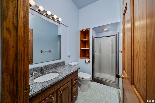 full bath with a stall shower, vanity, and toilet