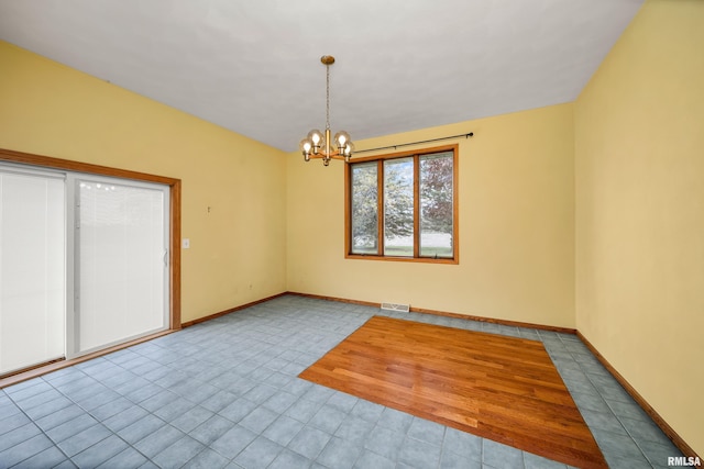 empty room featuring an inviting chandelier, baseboards, visible vents, and tile patterned flooring