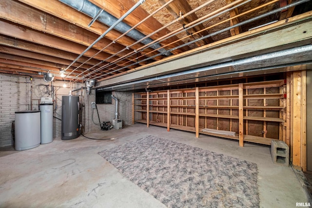 unfinished basement featuring gas water heater