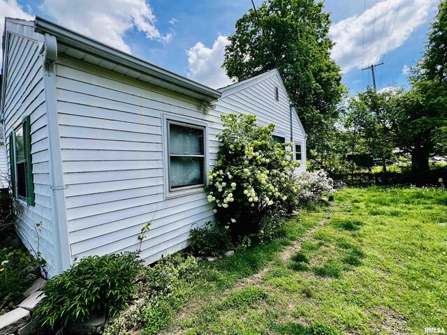 57 W 3rd St, New Burnside, IL 62967 - view of home's exterior with a yard