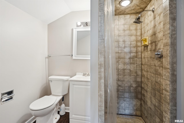 full bathroom with lofted ceiling, vanity, toilet, and tiled shower