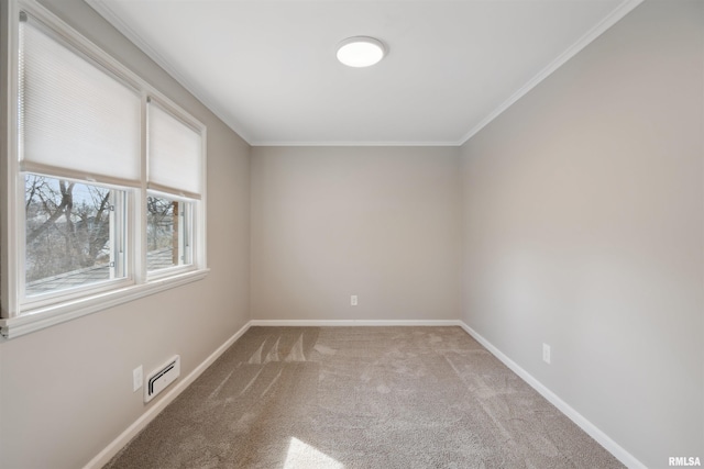 unfurnished room featuring baseboards, visible vents, carpet floors, and crown molding