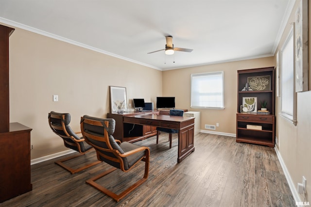 office area featuring a ceiling fan, wood finished floors, baseboards, ornamental molding, and visible vents