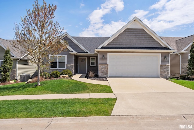 4743 Pheasant Creek Ave, Davenport, IA 52807 - craftsman house with driveway, stone siding, a front yard, and a garage