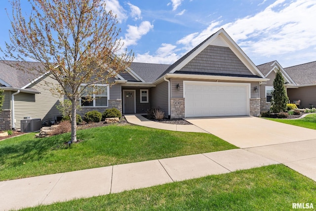 4743 Pheasant Creek Ave, Davenport, IA 52807 - view of front of property featuring a garage, driveway, stone siding, and a front yard