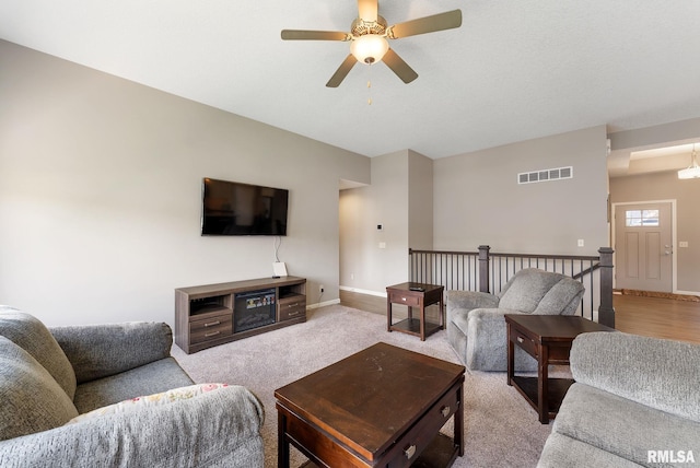 4743 Pheasant Creek Ave, Davenport, IA 52807 - living room with carpet floors, visible vents, a ceiling fan, and baseboards