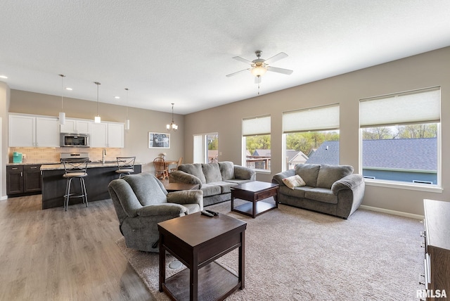 4743 Pheasant Creek Ave, Davenport, IA 52807 - living room with a ceiling fan, baseboards, recessed lighting, and light wood-style flooring