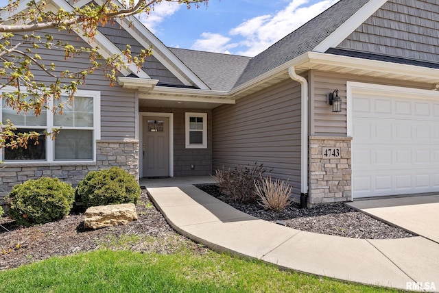 4743 Pheasant Creek Ave, Davenport, IA 52807 - view of exterior entry featuring roof with shingles and stone siding