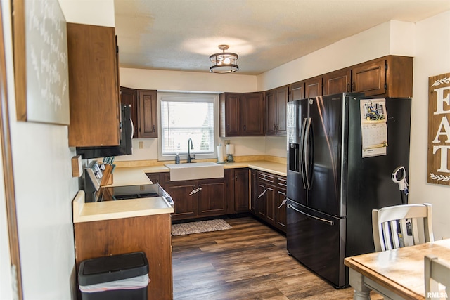 3122 Gross Gables St, Quincy, IL 62305 - kitchen with dark wood-style floors, a sink, dark brown cabinetry, light countertops, and black appliances