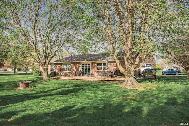 3122 Gross Gables St, Quincy, IL 62305 - rear view of house featuring a wooden deck, brick siding, and a yard