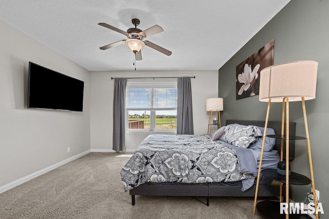 bedroom with a textured ceiling, ceiling fan, carpet flooring, and baseboards