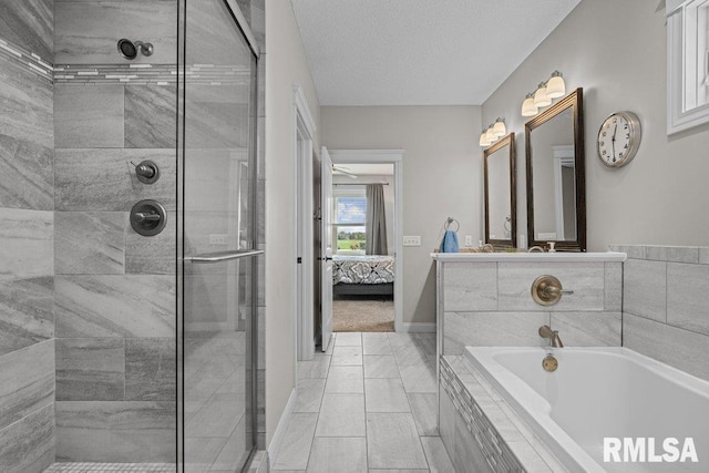ensuite bathroom with vanity, a shower stall, a bath, and ensuite bathroom