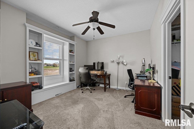 office with carpet, ceiling fan, and a textured ceiling