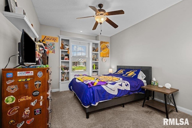 carpeted bedroom featuring baseboards and ceiling fan