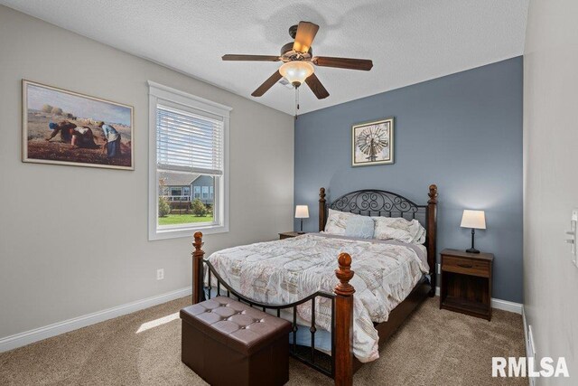 carpeted bedroom with baseboards, a ceiling fan, and a textured ceiling