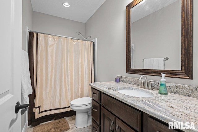 bathroom featuring curtained shower, toilet, and vanity