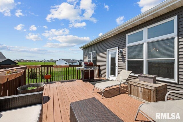 wooden terrace with a grill